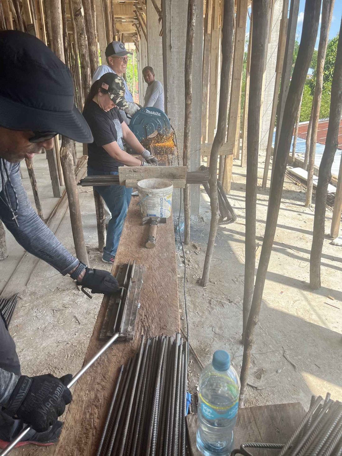 Team members cutting and bending steel reinforcing bar on site