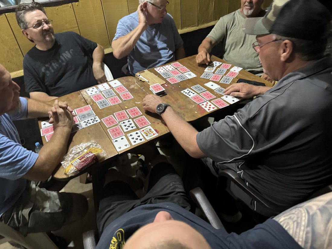 Team members playing dominoes together at the end of the day