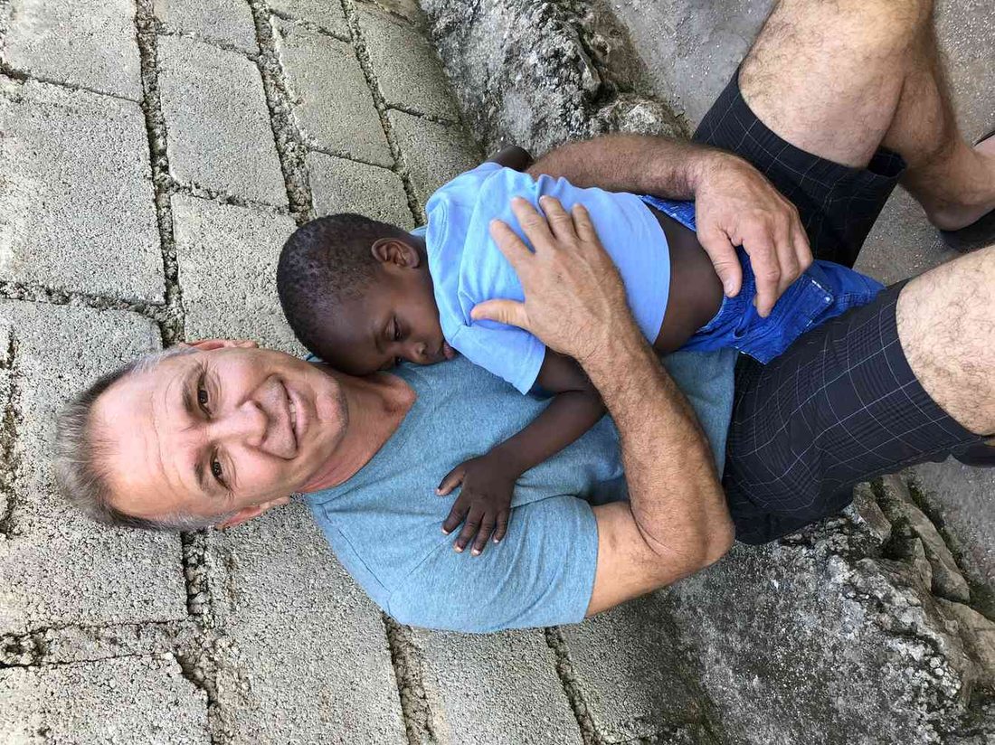 A team member holding a sleeping child