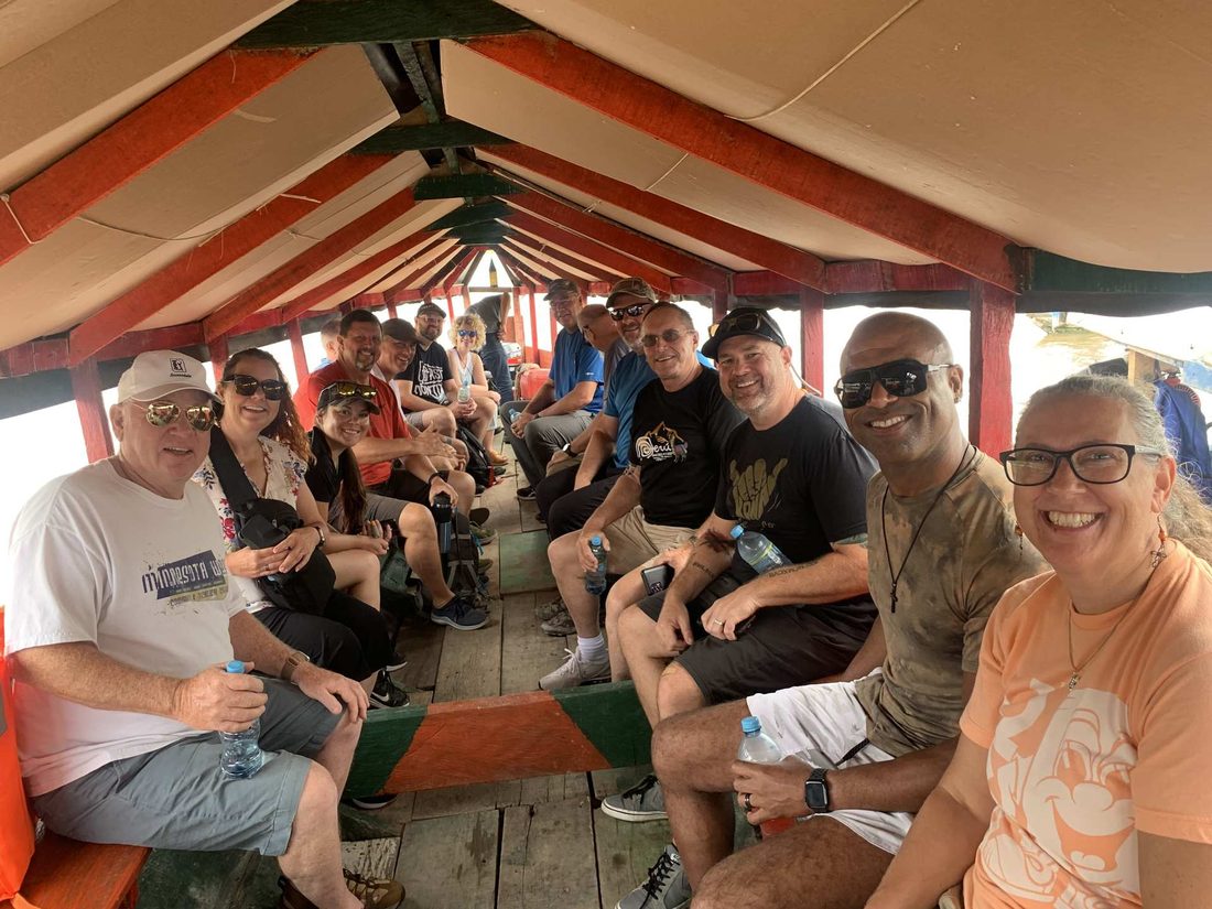 The team travelling together in a covered boat